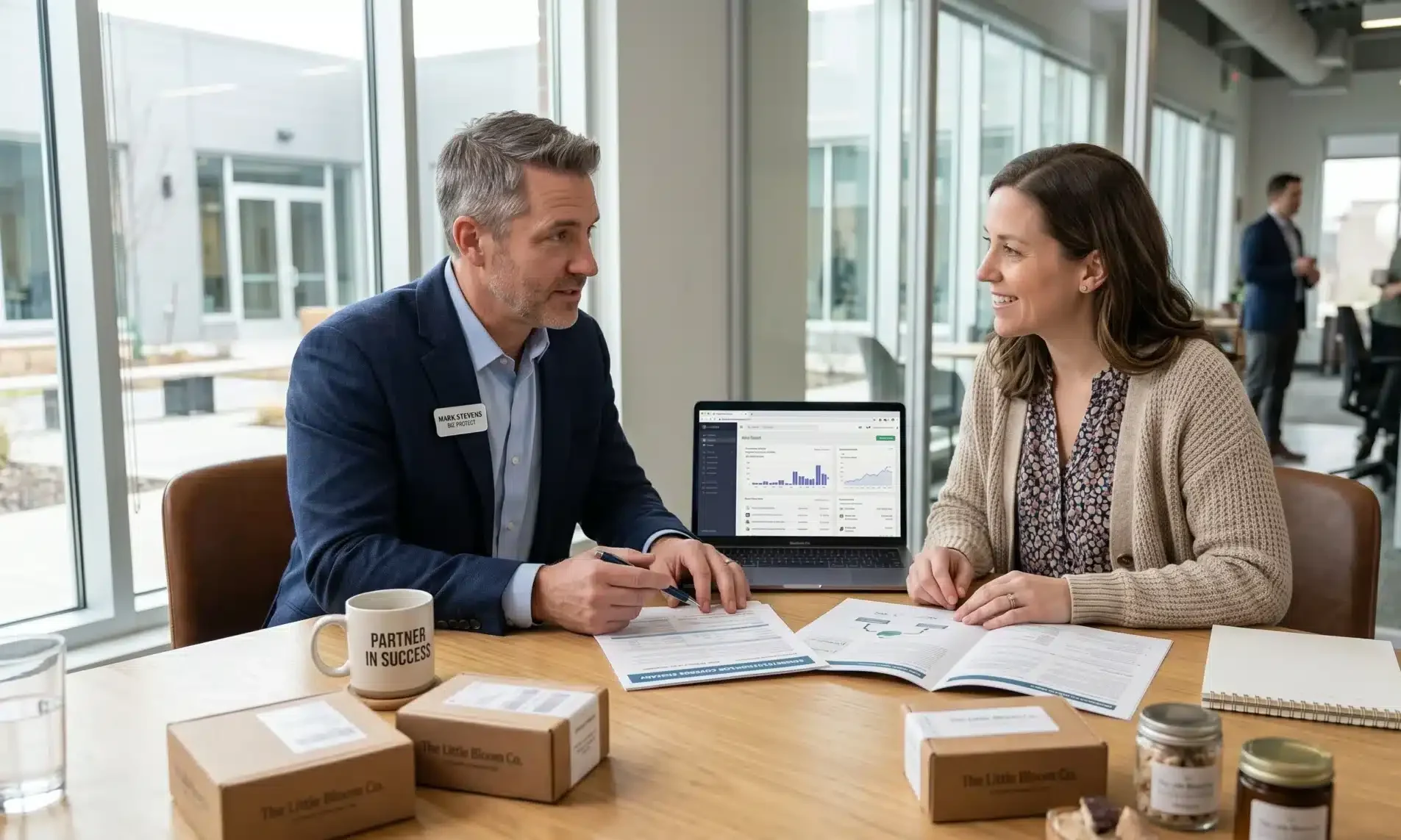 Insurance advisor meeting with an online retailer to review policies and risk protection through Ecommerce Business Insurance.